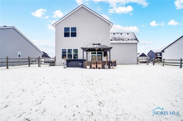 snow covered house featuring a gazebo