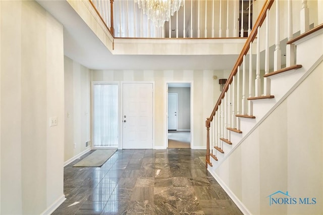 foyer with a notable chandelier and a high ceiling