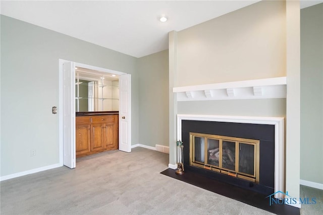 unfurnished living room featuring light colored carpet