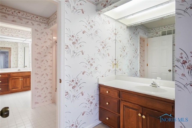 bathroom featuring tile patterned flooring and vanity