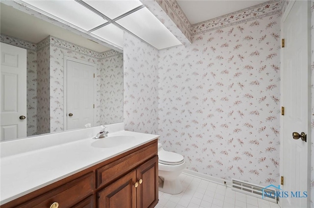 bathroom with vanity, toilet, and tile patterned flooring