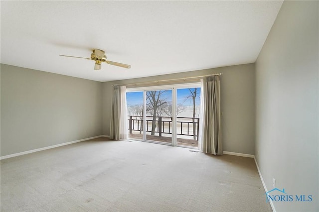 carpeted spare room with ceiling fan