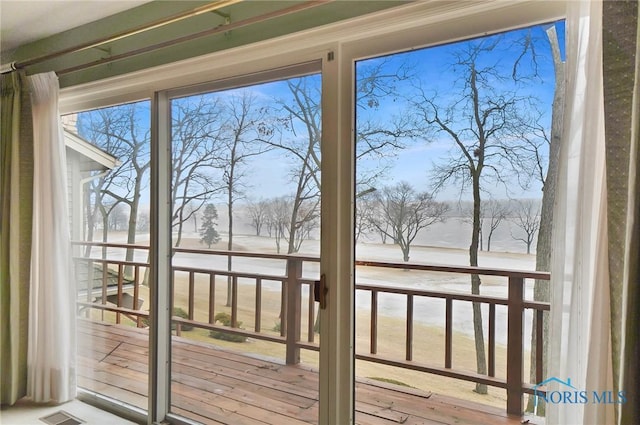 doorway to outside featuring a water view