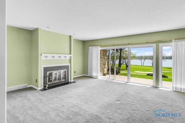 3865 River Rd, Toledo, OH 43614 - unfurnished living room with carpet floors, a textured ceiling, baseboards, a fireplace with flush hearth, and a water view