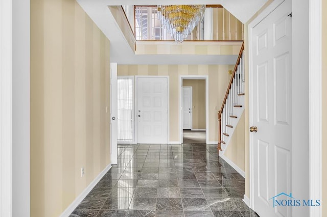 3865 River Rd, Toledo, OH 43614 - foyer entrance featuring baseboards, marble finish floor, stairs, and a chandelier