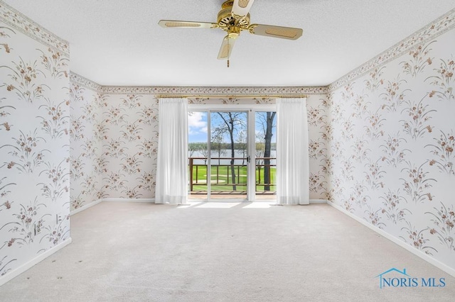 3865 River Rd, Toledo, OH 43614 - carpeted empty room with baseboards, a ceiling fan, and wallpapered walls