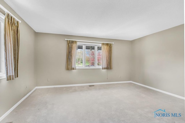 3865 River Rd, Toledo, OH 43614 - spare room featuring baseboards, carpet flooring, and visible vents