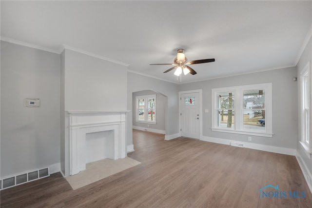 unfurnished living room with light hardwood / wood-style flooring, ornamental molding, and ceiling fan