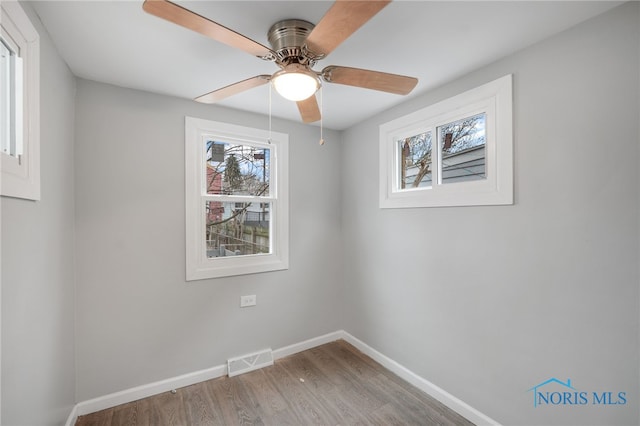 unfurnished room with hardwood / wood-style flooring and ceiling fan