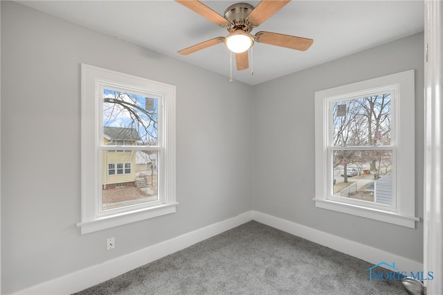 empty room with ceiling fan, a healthy amount of sunlight, and carpet floors