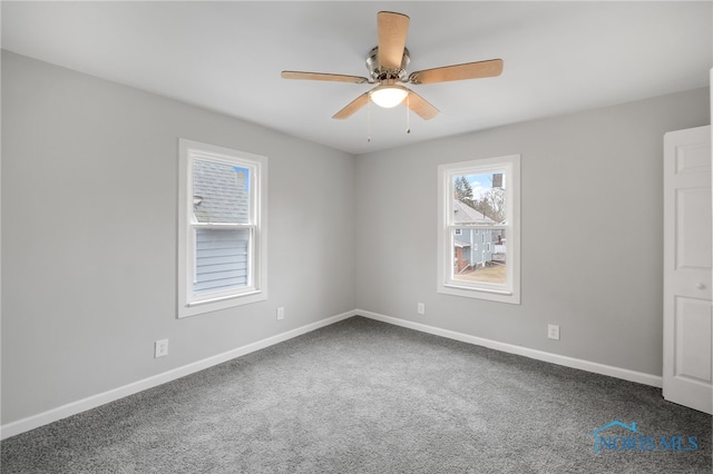 unfurnished room featuring ceiling fan and carpet flooring