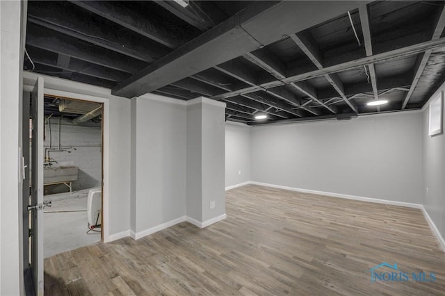 basement with hardwood / wood-style flooring