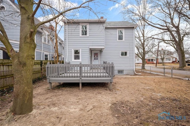 rear view of property featuring a deck