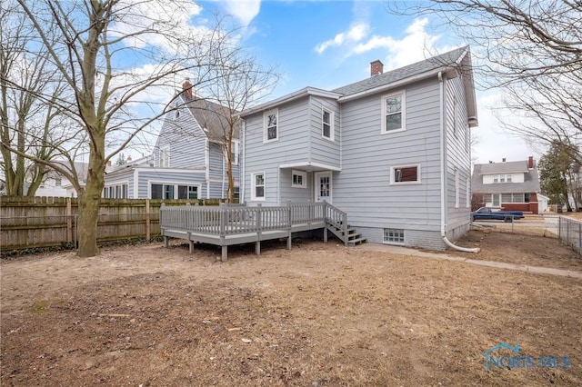 rear view of property with a wooden deck