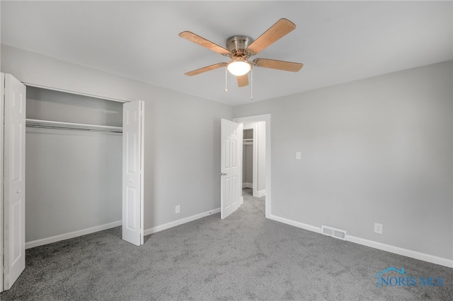 unfurnished bedroom featuring ceiling fan, a closet, and carpet