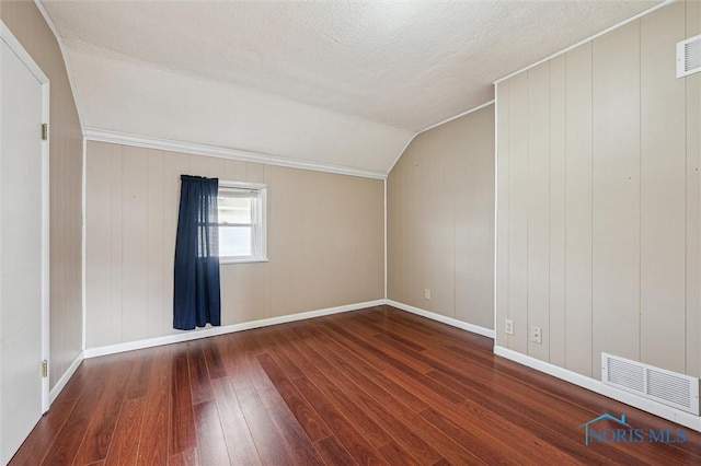 bonus room featuring hardwood / wood-style flooring, lofted ceiling, and a textured ceiling