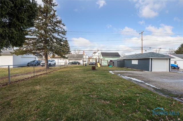 view of yard featuring a garage and an outdoor structure