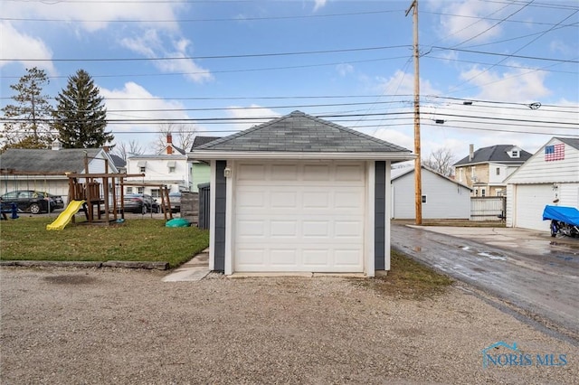 garage featuring a lawn