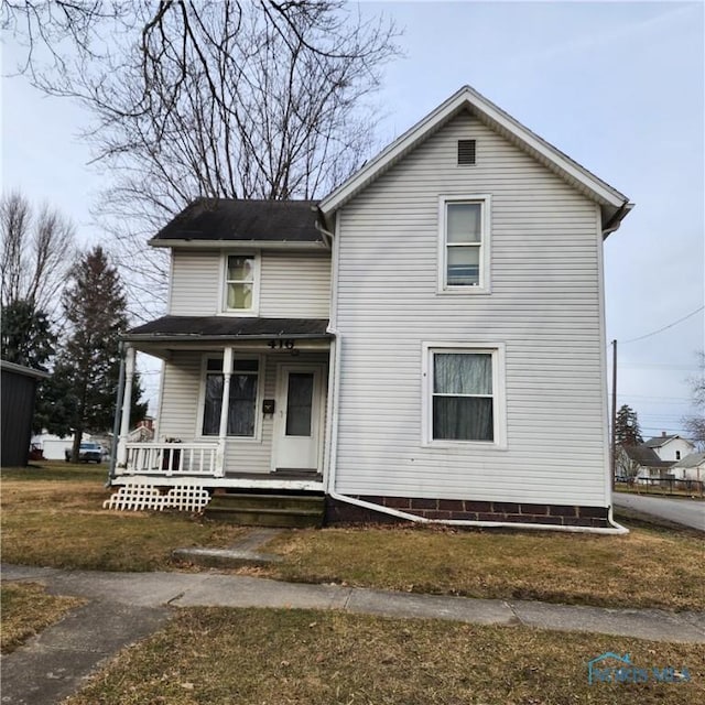 front facade with covered porch and a front lawn