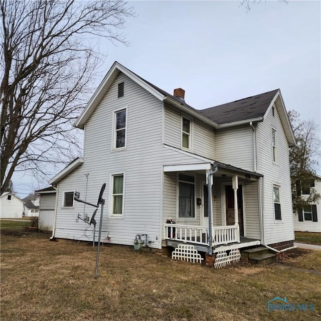 view of front of home featuring covered porch and a front lawn