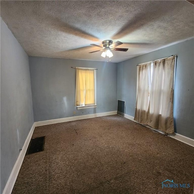 carpeted empty room with a textured ceiling and ceiling fan