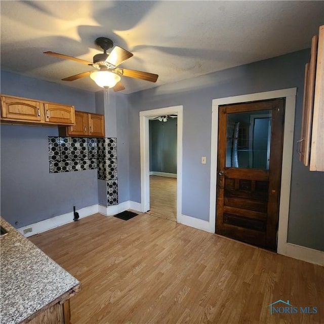 interior space with light hardwood / wood-style floors and ceiling fan