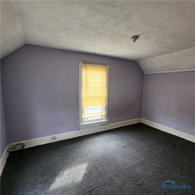 bonus room featuring carpet floors, a textured ceiling, and vaulted ceiling