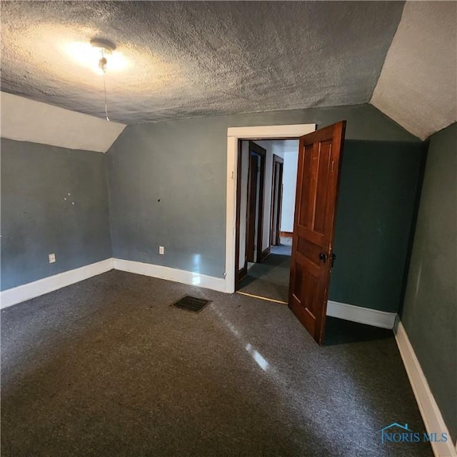 interior space featuring lofted ceiling and a textured ceiling