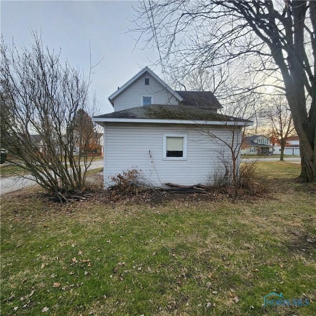 view of home's exterior with a lawn