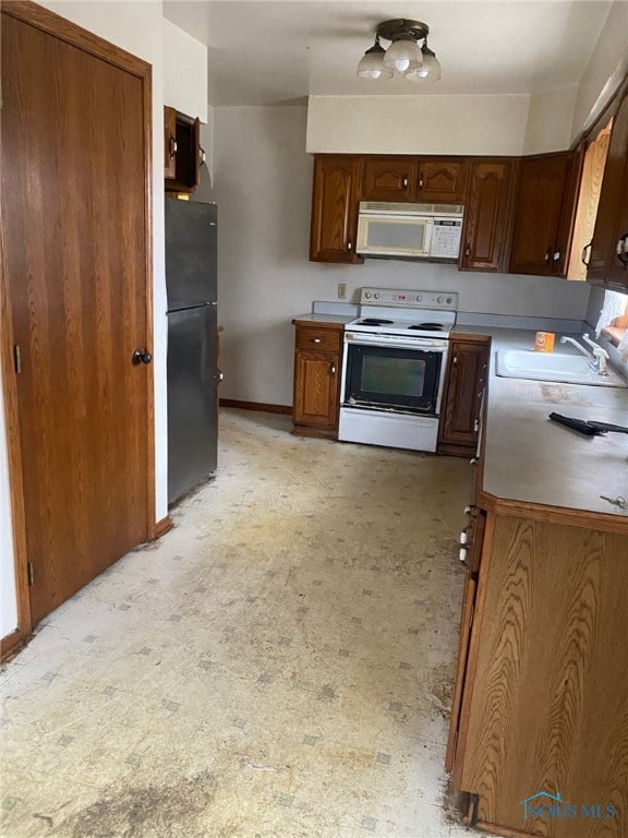 kitchen featuring sink and white appliances