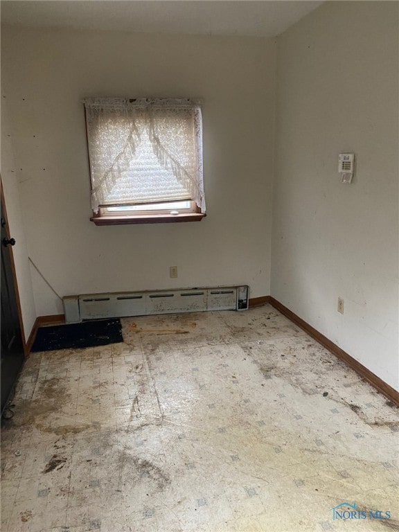 spare room featuring a baseboard heating unit