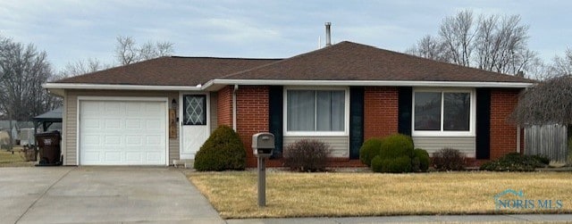 ranch-style home featuring a garage and a front yard