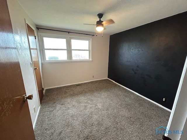 empty room with carpet floors and ceiling fan