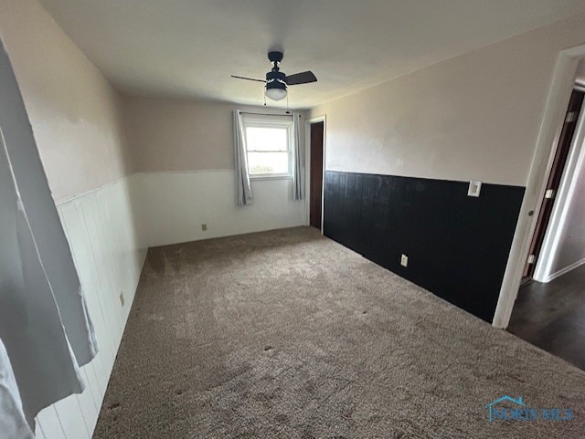 carpeted empty room featuring ceiling fan