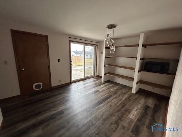 unfurnished dining area with dark hardwood / wood-style flooring