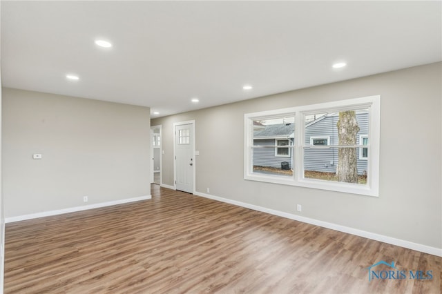 unfurnished room with light hardwood / wood-style floors