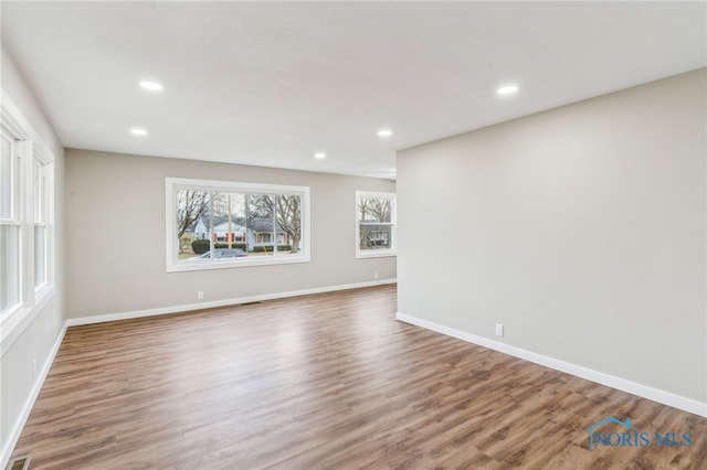 unfurnished room with hardwood / wood-style flooring