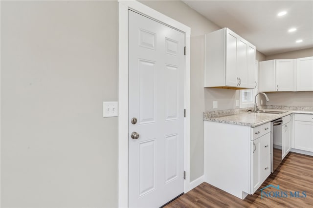 kitchen with white cabinetry, stainless steel dishwasher, dark hardwood / wood-style floors, and sink