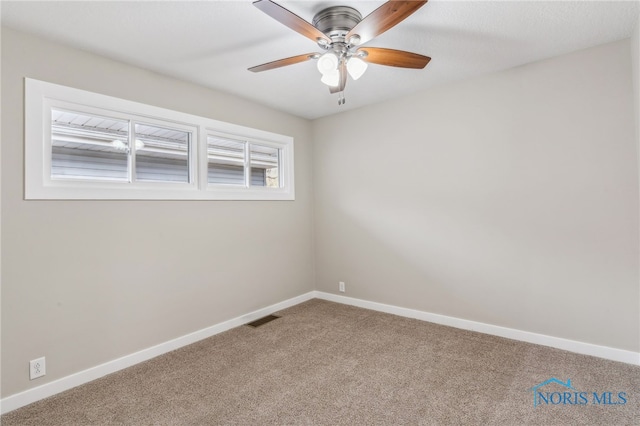 carpeted empty room featuring ceiling fan