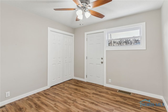 unfurnished room with ceiling fan and hardwood / wood-style floors