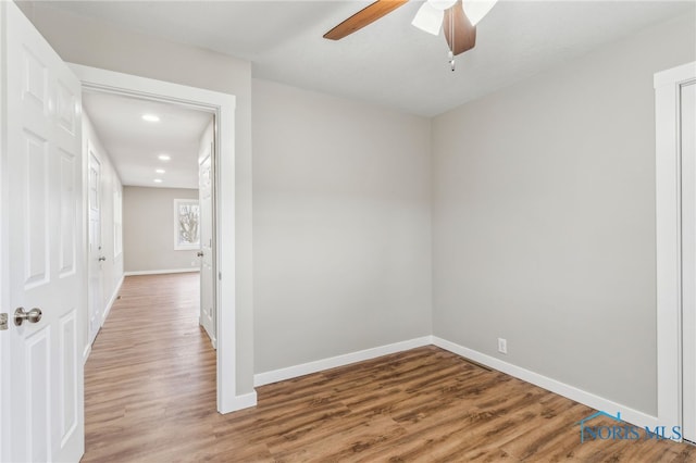 spare room featuring wood-type flooring and ceiling fan