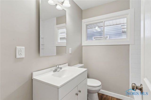 bathroom featuring hardwood / wood-style flooring, vanity, and toilet