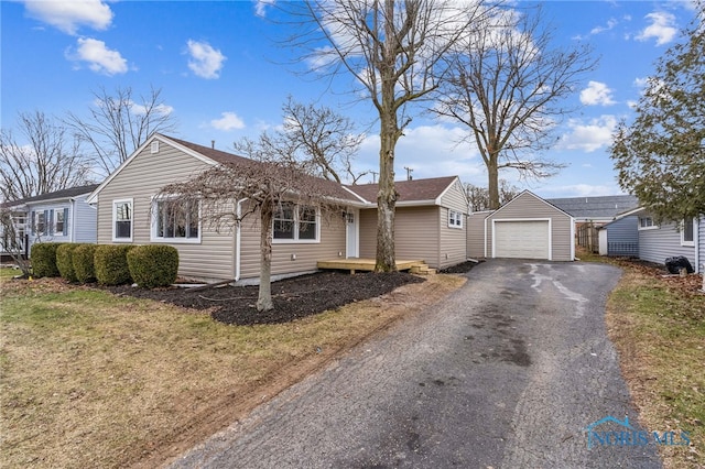 ranch-style home with an outbuilding, a garage, and a front lawn