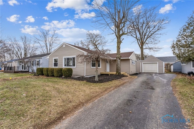 single story home with a garage, an outdoor structure, and a front lawn