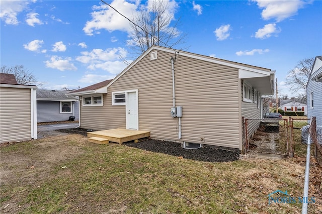 rear view of house featuring a yard