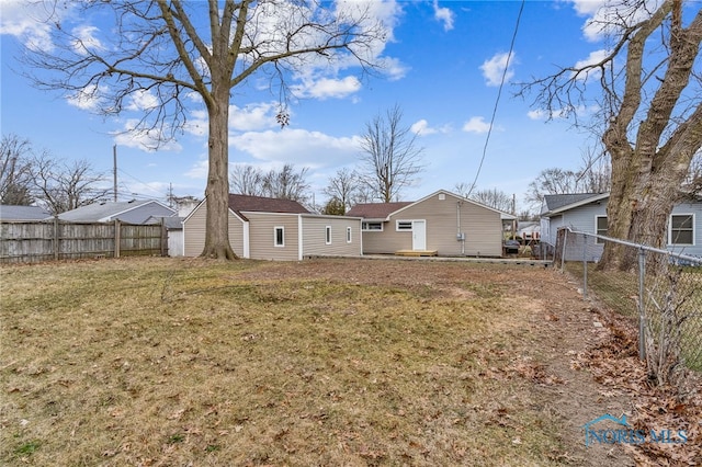 back of house with a lawn