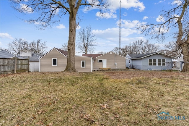 rear view of house with a yard