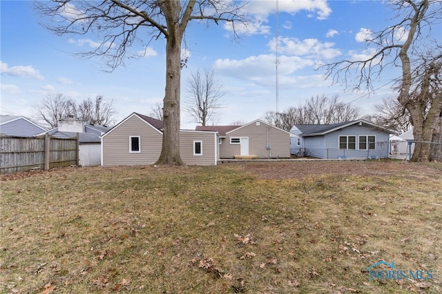 back of house with a yard