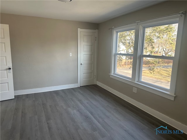 empty room featuring dark hardwood / wood-style flooring