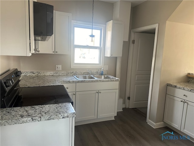 kitchen with black electric range oven, sink, hanging light fixtures, and white cabinets